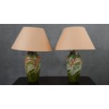 A pair of Minton Secessionist lamps with tube line stylised floral design on a green ground. Green