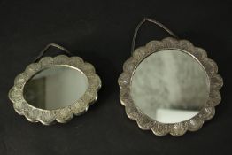 Two Turkish repousse design silver wedding mirrors with scalloped edges and raised floral and