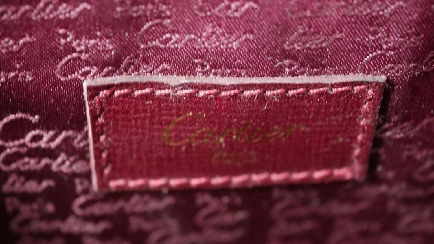 A leather Cartier clutch bag with red silk interior with Cartier writing and raised Cartier monogram - Image 7 of 9
