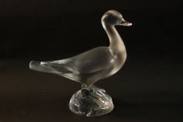 A Lalique crystal frosted and clear glass duck figure, standing on a round crystal base, signed