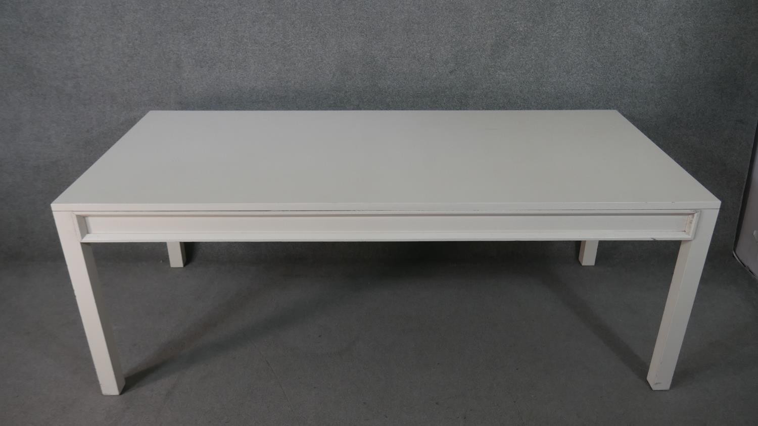 A contemporary white painted wood dining table, of rectangular form, on square section legs. H.75 - Image 2 of 4