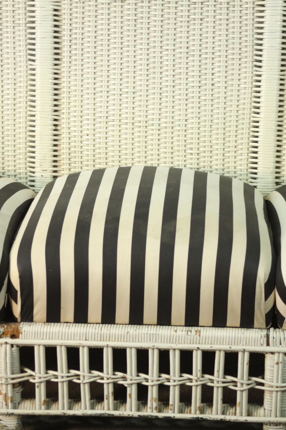 A white painted rattan garden three seater sofa, of woven construction, with a black and white - Image 8 of 9