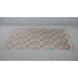 A contemporary multicoloured chequered woolen rug. L.170 W.90cm
