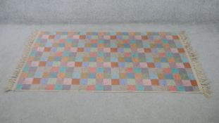 A contemporary multicoloured chequered woolen rug. L.170 W.90cm