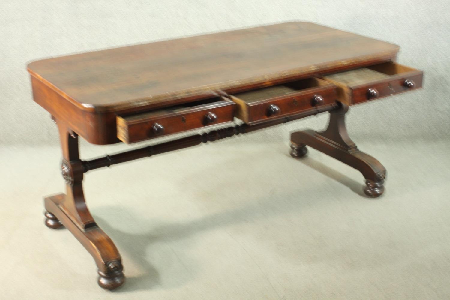 A Victorian mahogany library table, with three short drawers, over end supports joined by a turned - Image 4 of 9