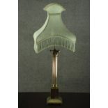 A 20th century brass table lamp, in the form of a Corinthian column, on a square section step down