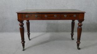 A William IV mahogany library table, with a tooled green leather skiver, over three short drawers,