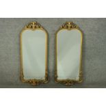 A pair of 20th century gilt mirrors, with a scrolling foliate crest, and a rope twist border, over a