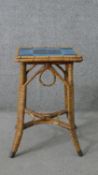 A wicker jardiniere stand, the square top with two shades of blue tiles, the splayed legs joined