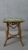 A wicker occasional table, the square top with green foliate Art Nouveau tiles, the splayed legs