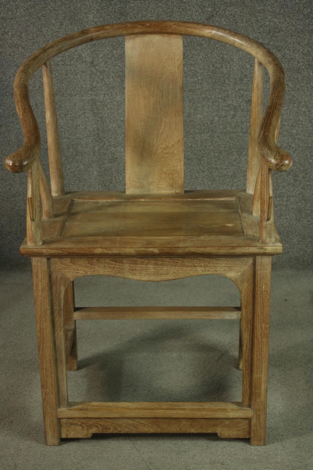 A pair of Chinese teak horseshoe back armchairs, with a plain splat back, the legs joined by - Image 3 of 17