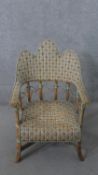 A wicker conservatory open armchair, with a triple hump back, on splayed legs joined by X stretchers