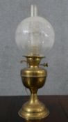 A Victorian brass converted oil lamp, with a globular etched glass shade. H.52 W.15cm