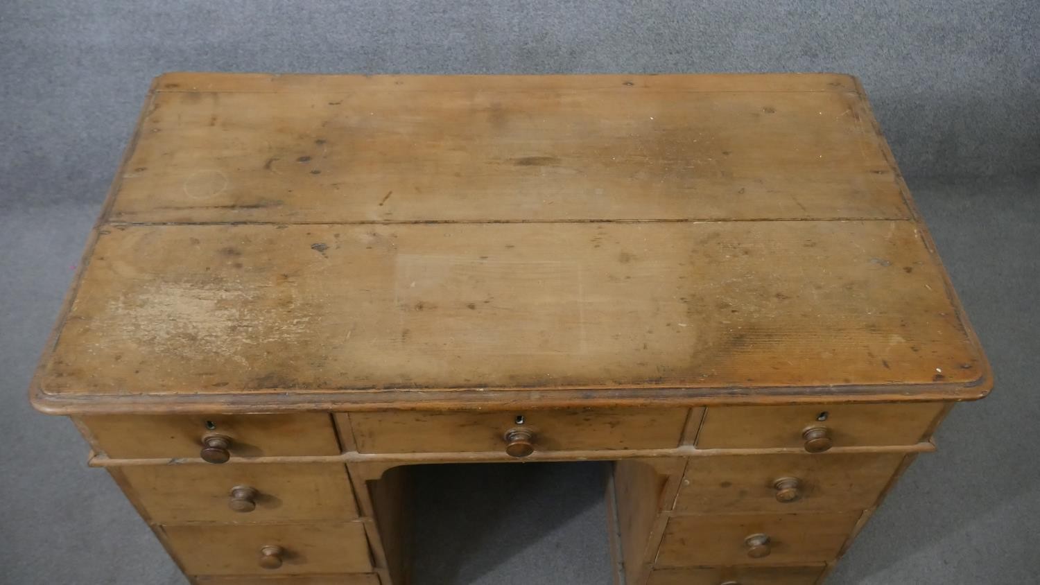 A Victorian pine kneehole desk, the rectangular top with a moulded edge, over an arrangement of nine - Image 2 of 6