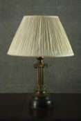 A 20th century brass Ionic column table lamp, with an ivory pleated shade. H.60 W.40cm.