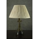 A 20th century brass Ionic column table lamp, with an ivory pleated shade. H.60 W.40cm.