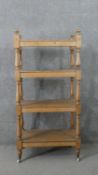 A Victorian pine whatnot, with four shelves joned by baluster turned stems. H.125 W.59 D.38cm