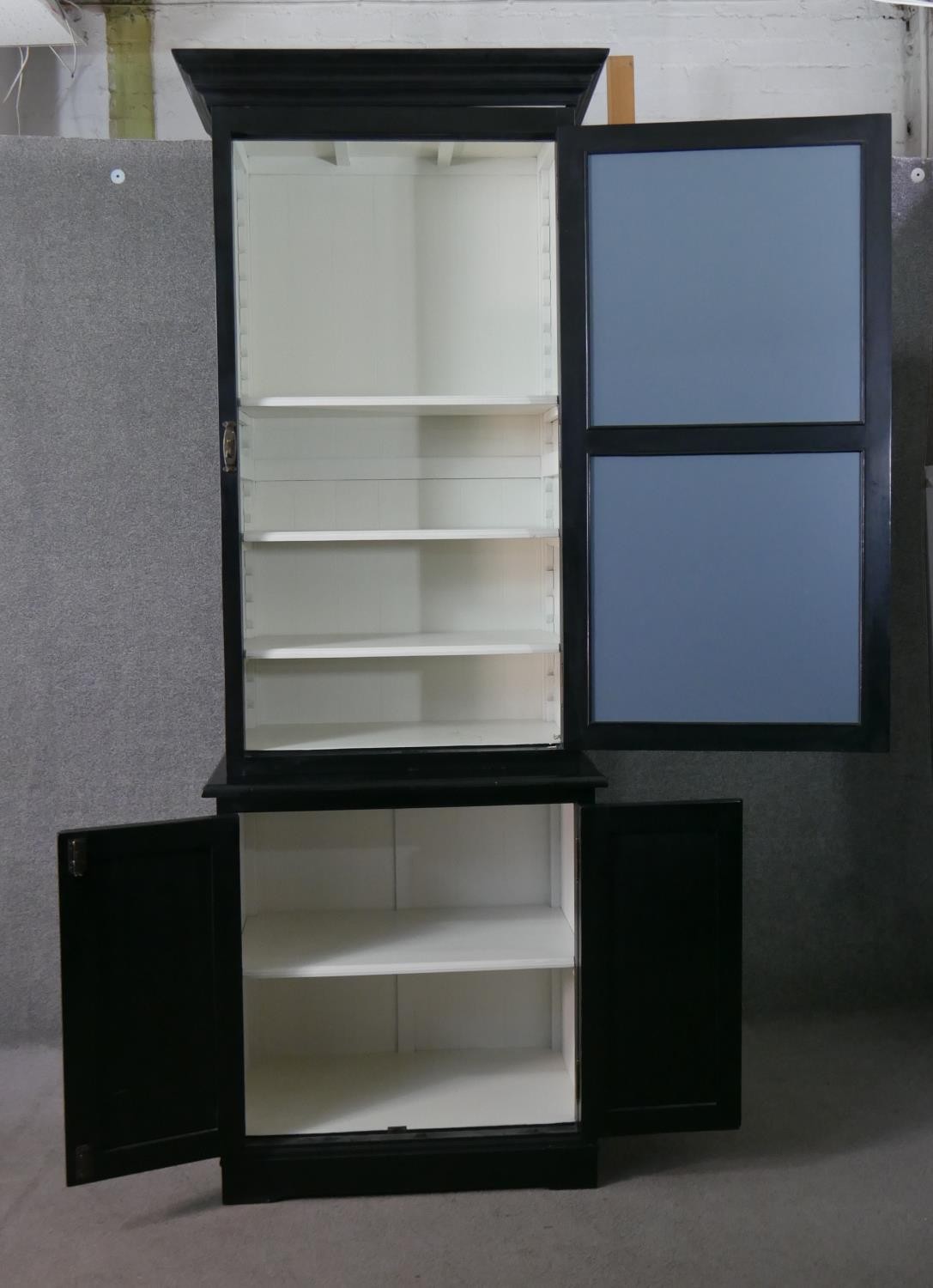 A contemporary ebonised tall cabinet, with a moulded cornice over a mirrored door, over two cupboard - Image 7 of 9