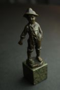 A bronze figure of an Austrian boy mounted on a serpentine marble base. H.13cm.