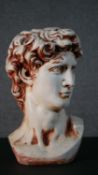 A 20th century painted plaster bust of Michael Angelo's David. H.43 W.25cm