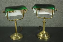 A pair of brass banker's lamps, with adjustable green glass shades, on circular bases. H.38cm.