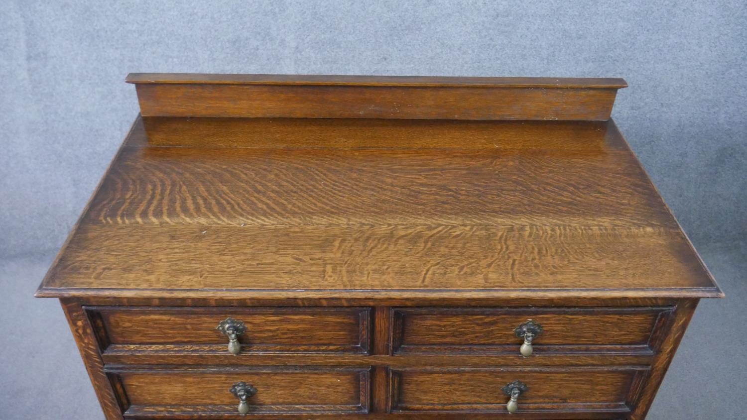 An early 20th century antique style oak chest of drawers, with a gallery back over four long - Image 4 of 7