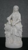 A Parian ware model of a girl standing holding a sheaf of corn. H.34 W.14 D.10cm