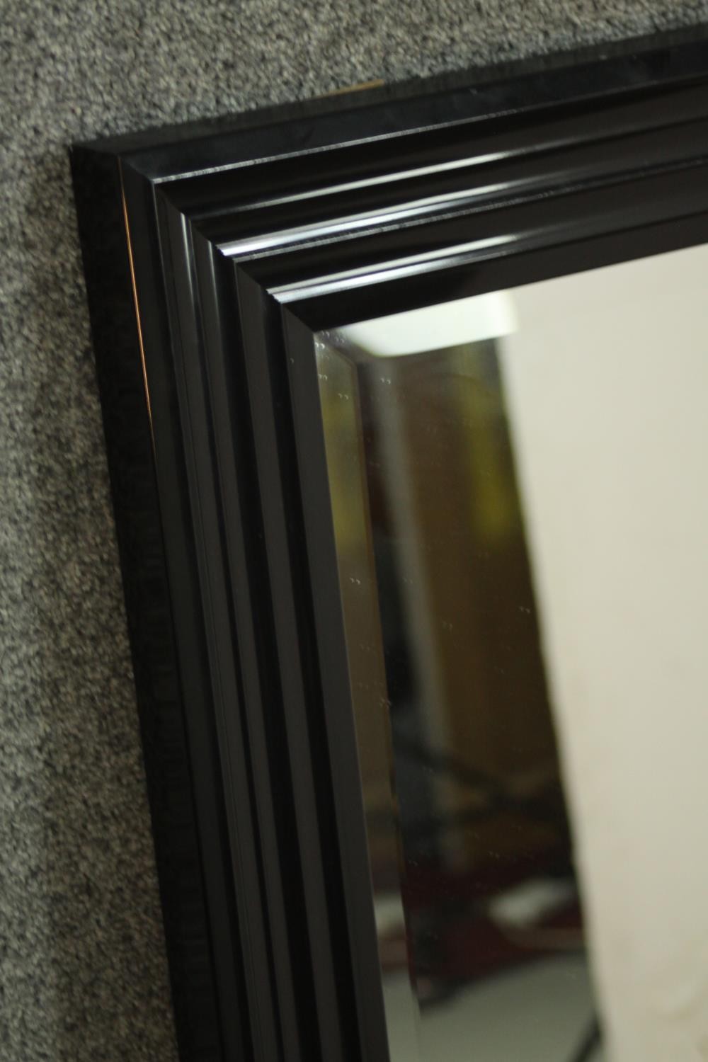 A contemporary ebonised mirror, with a rectangular mirrored plate in a moulded frame. H.107 W.76cm - Image 5 of 6