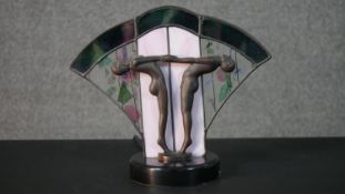 An Art Deco lead stained glass fan table lamp with two spelter dancers holding hands. H.27 W.31 D.