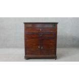 A 19th century French mahogany washstand, the rising lid revealing a white marble surface, over a