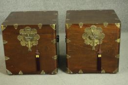 A pair of 20th century Chinese hardwood trunks, with brass banding and locks, the interior lined