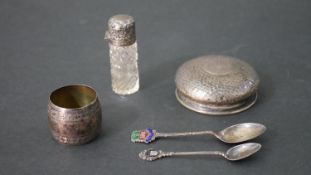 A collection of silver, including a silver topped cut glass perfume bottle, a silver napkin ring,