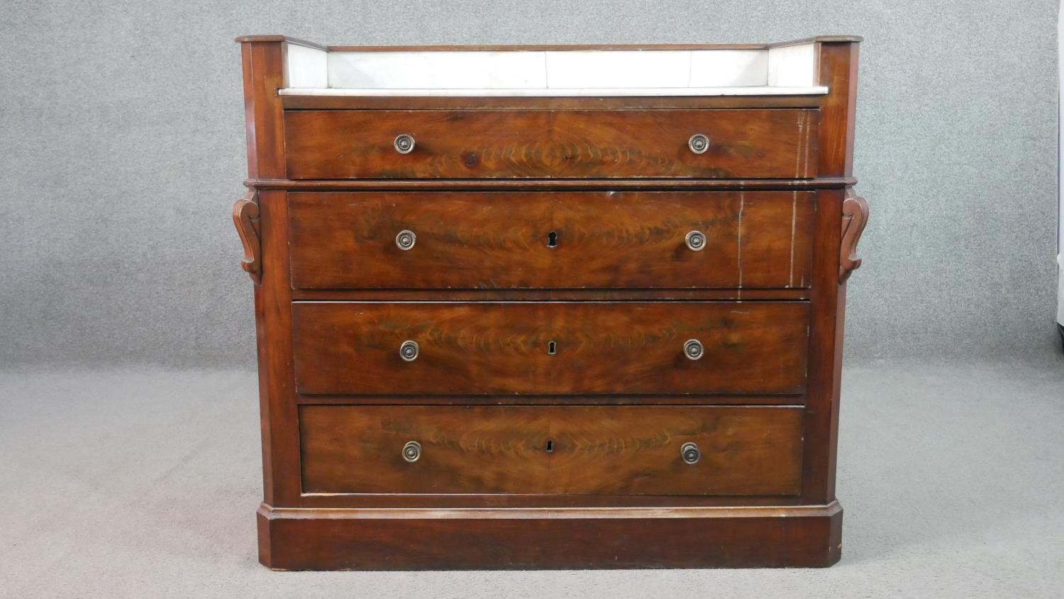 A Victorian flame mahogany dressing chest, with a white marble washstand top, over four long