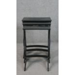 A nest of three black lacquered tables, the rectangular top with remnants of decoration, on