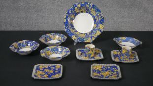 A Royal Doulton four person part coffee set, decorated with yellow blossom on a blue ground.