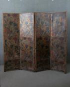 A Victorian painted and embossed leather four fold screen, decorated with intertwined flowers