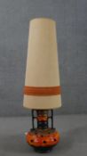 A mid century West German twin handled design fat lava ceramic lamp with embellished fabric shade.