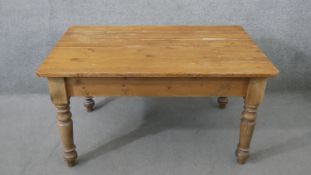 A Victorian pine kitchen table, the rectangular plank top over an end drawer with a knob handle,