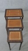 A nest of three reproduction mahogany occasional tables, with tooled brown leather inserts, on