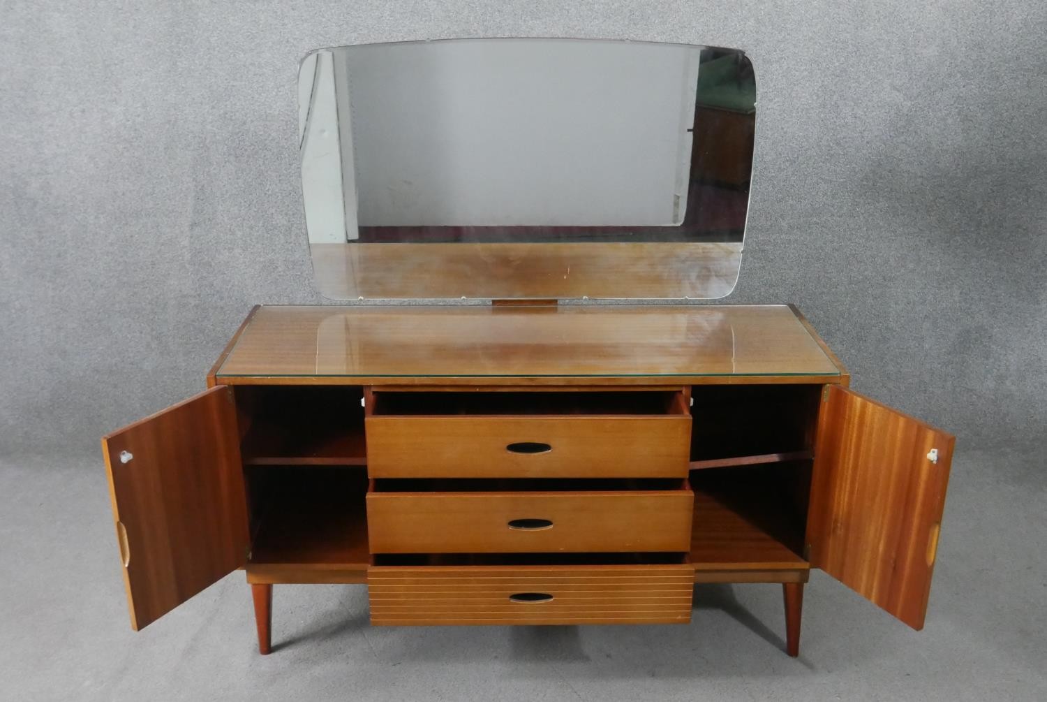 A circa 1960s teak dressing table, with a frameless mirror over three short drawers flanked by - Image 3 of 8