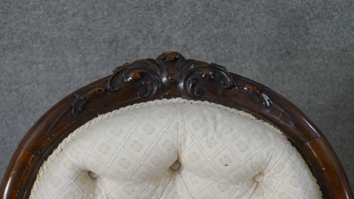 A Victorian walnut open armchair, upholstered in patterned ivory fabric, with an oval buttoned back, - Image 5 of 7