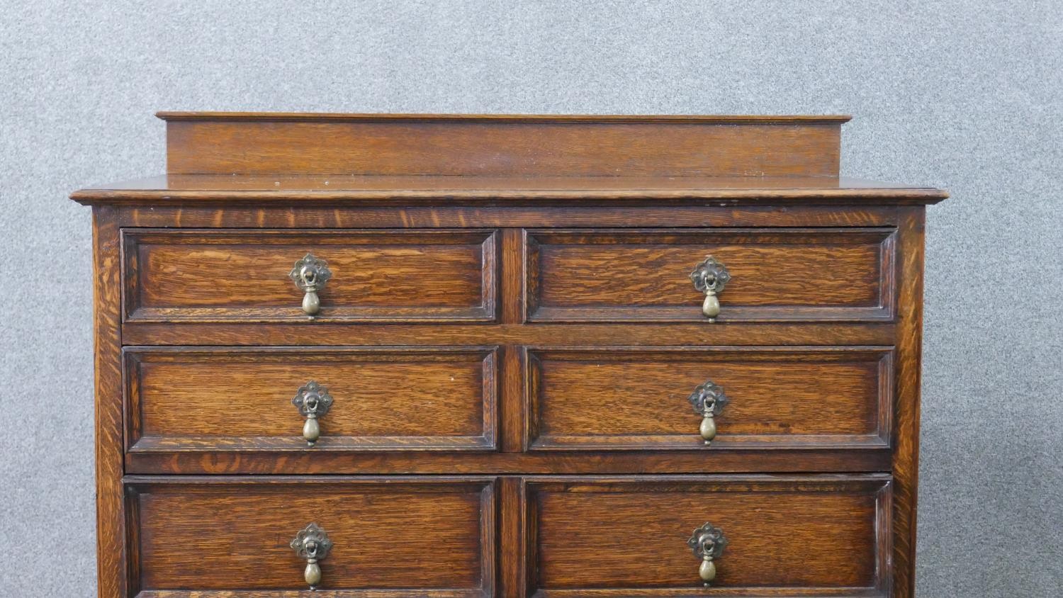 An early 20th century antique style oak chest of drawers, with a gallery back over four long - Image 2 of 7