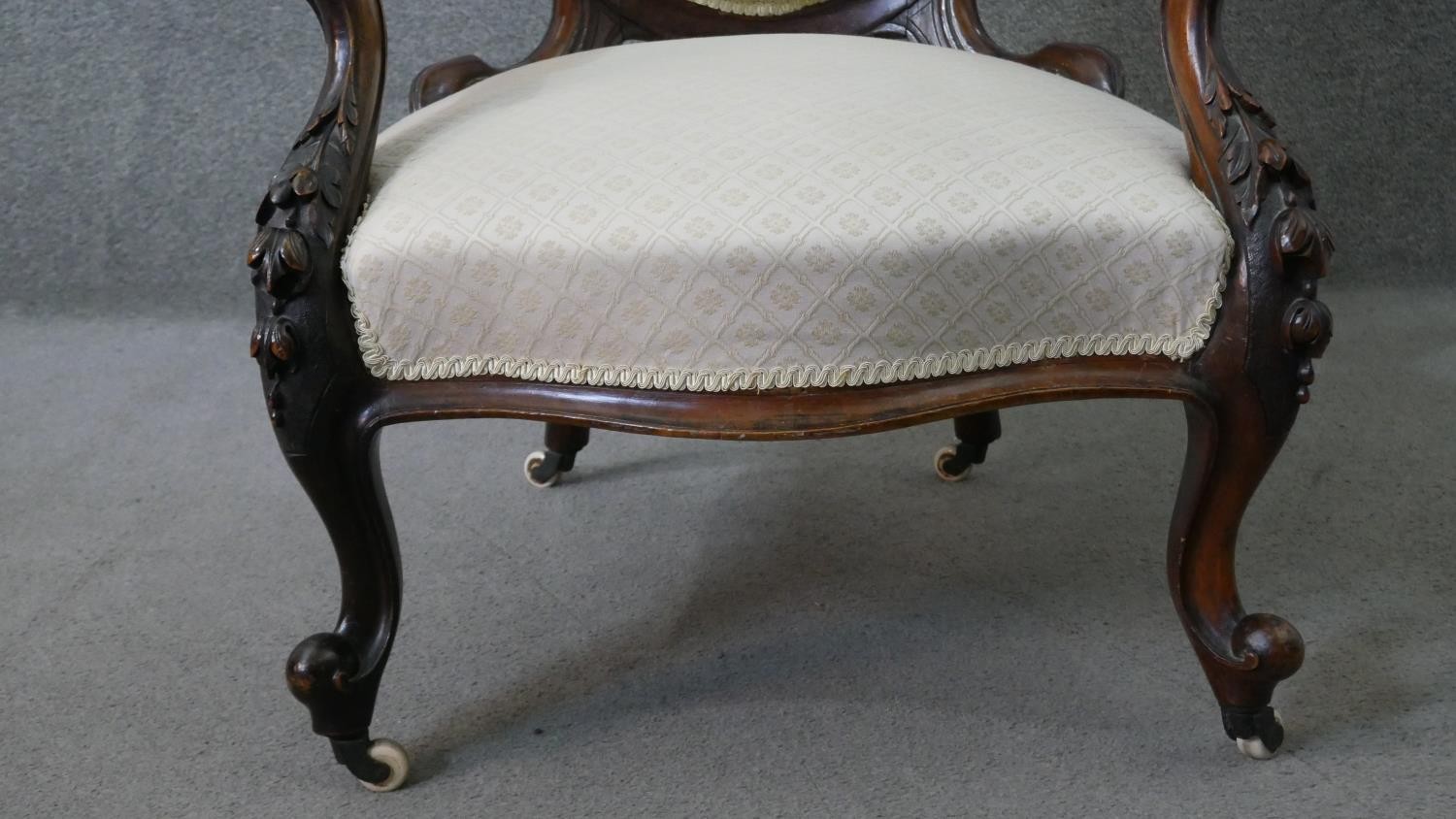 A Victorian walnut open armchair, upholstered in patterned ivory fabric, with an oval buttoned back, - Image 2 of 7