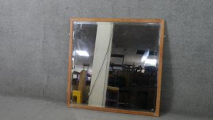 An early 20th century oak framed mirror, of square form with a bevelled mirror plate. H.104 D.105cm