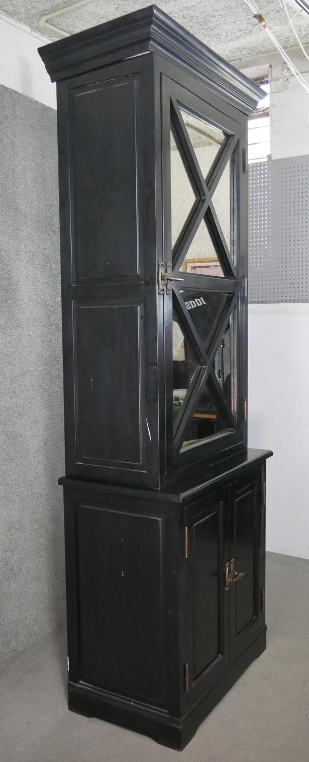 A contemporary ebonised tall cabinet, with a moulded cornice over a mirrored door, over two cupboard - Image 9 of 9