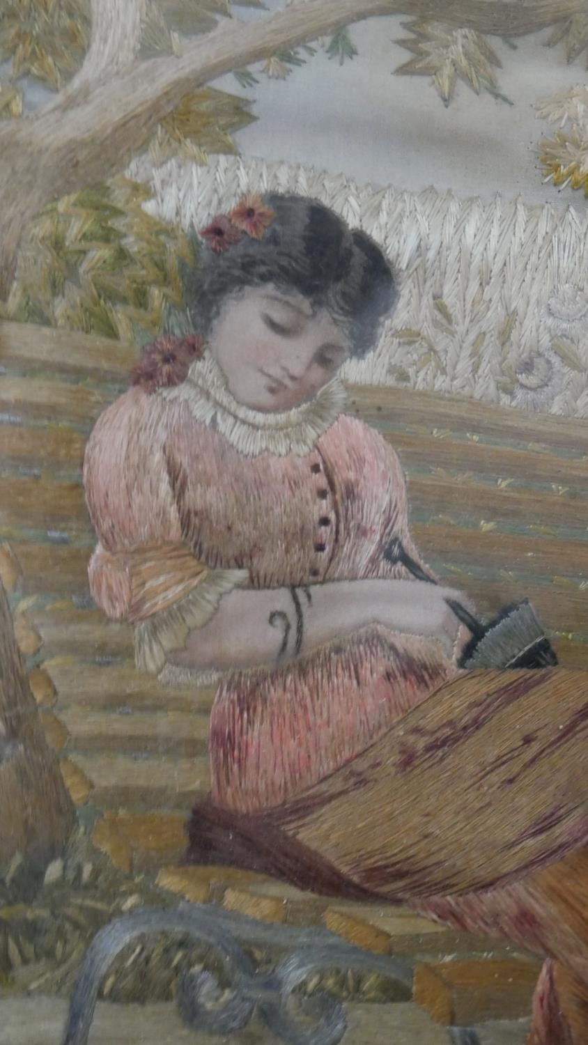 A framed and glazed 19th century Italian silk work embroidery of a lady sitting on a bench with - Image 4 of 4