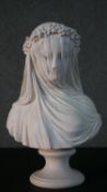 A resin bust of the veiled maiden on a pedestal base. H.37 W.24cm