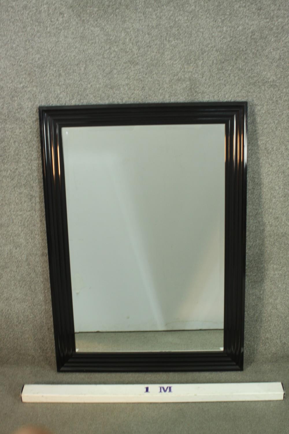 A contemporary ebonised mirror, with a rectangular mirrored plate in a moulded frame. H.107 W.76cm - Image 2 of 6