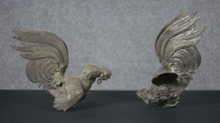 A pair of silver plated fighting cockerels with feather detailing. H.25 W.20 D.15cm