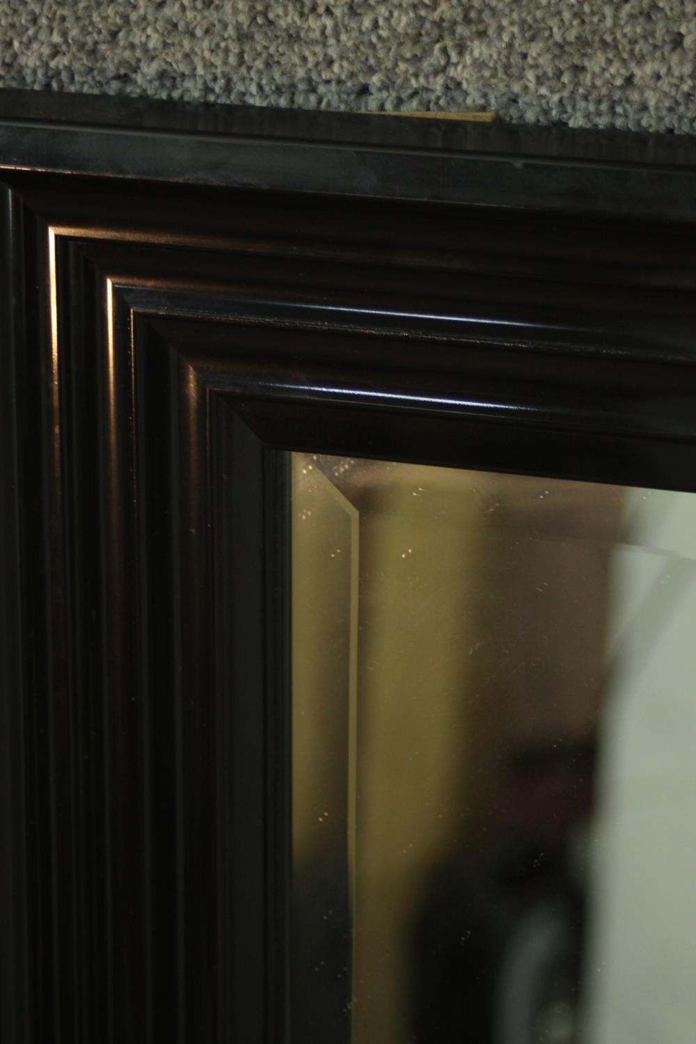 A contemporary ebonised mirror, with a rectangular mirrored plate in a moulded frame. H.107 W.76cm - Image 6 of 6